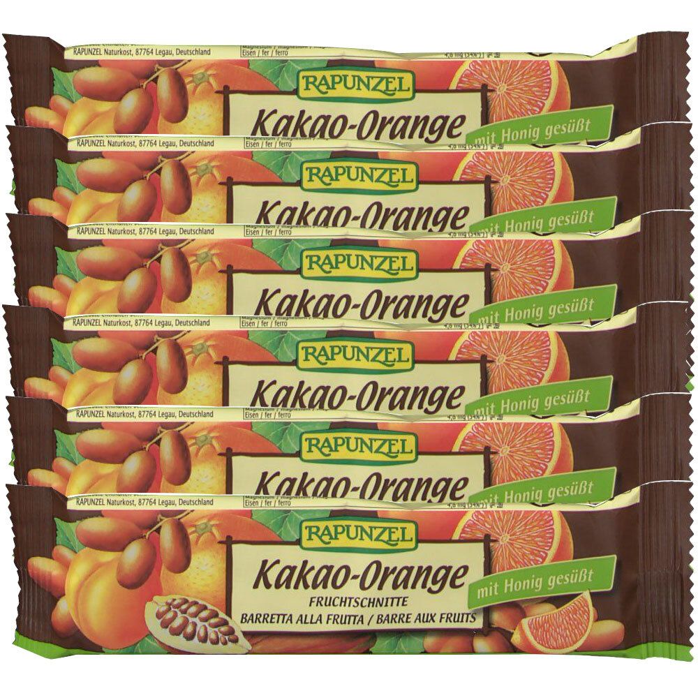 Plusieurs barres de fruits emballées. Inscription : RAPUNZEL Kakao-Orange, mit Honig gesüßt. Illustration de cacao, orange et dattes.