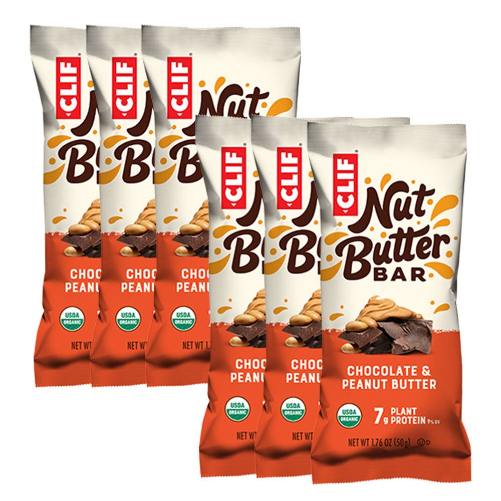 Plusieurs barres CLIF Nut Butter, saveur chocolat et beurre de cacahuète. Emballage avec sceau USDA Organic. Inscription : 7g de protéines végétales.