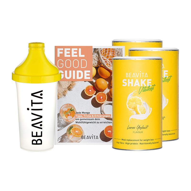 Pack de régime avec shaker, brochure et boîtes. Shaker et boîtes jaunes, brochure avec texte. Nom du produit: BEAVITA. Inscription: Shake Vital, Zitrone-Joghurt.