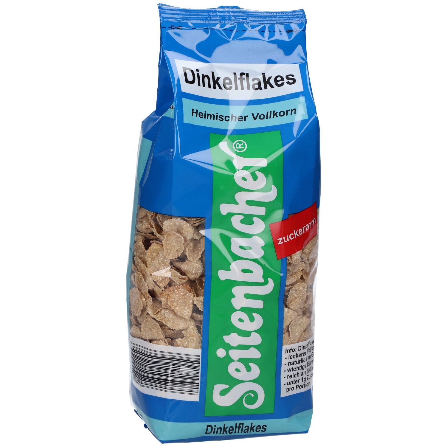 Paquet de Dinkelflakes. Sac bleu avec nom et logo du produit. Flocons visibles à travers le film transparent.