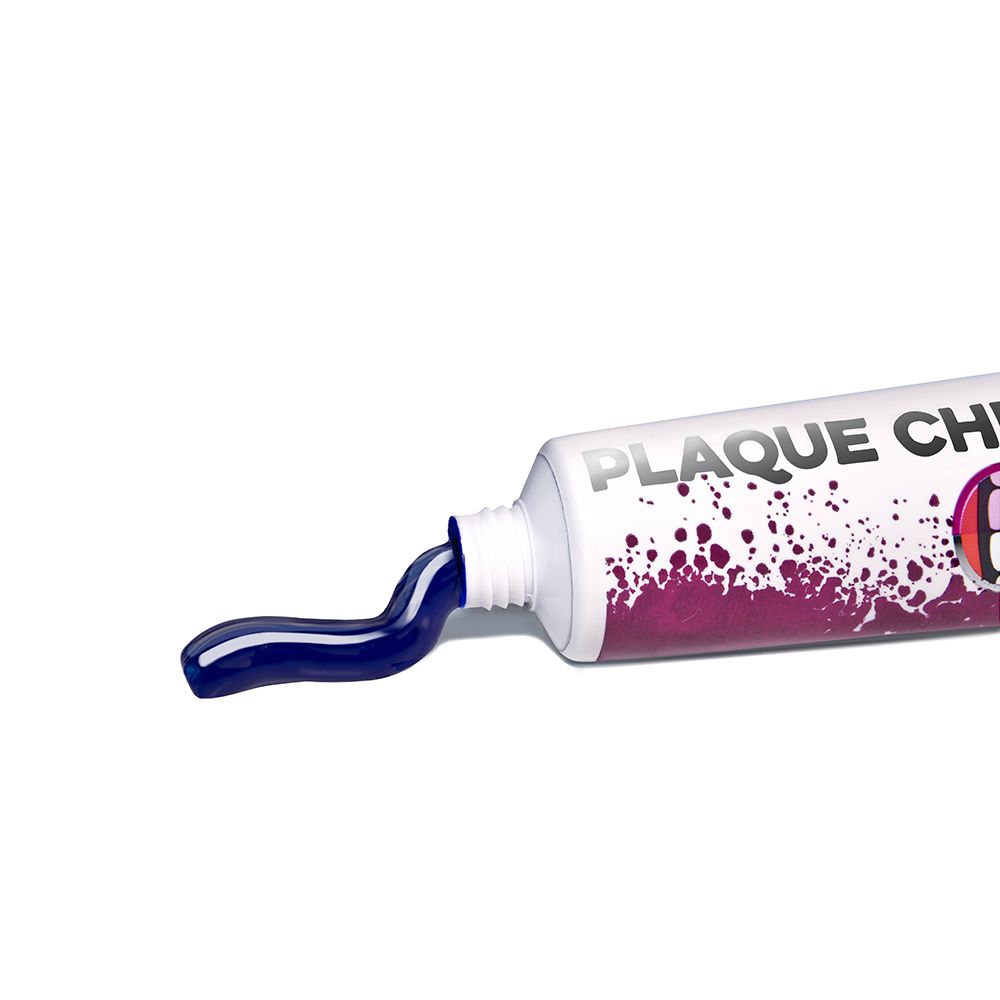Dentifrice sortant d'un tube. Dentifrice bleu. Tube avec l'inscription Plaque Checker.