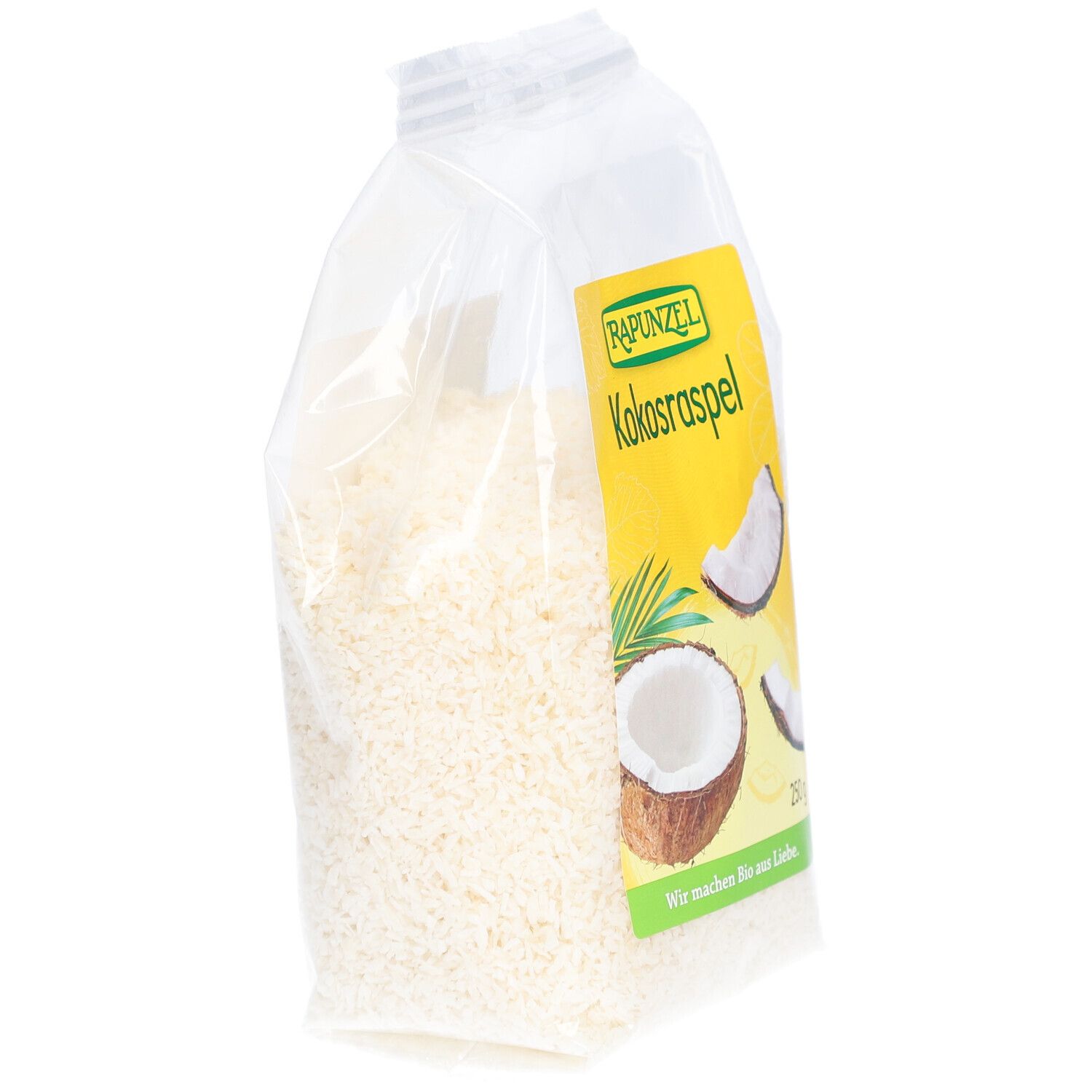 Sachet transparent de copeaux de noix de coco. Étiquette avec logo et nom du produit : Kokosraspel. Vue en biais.