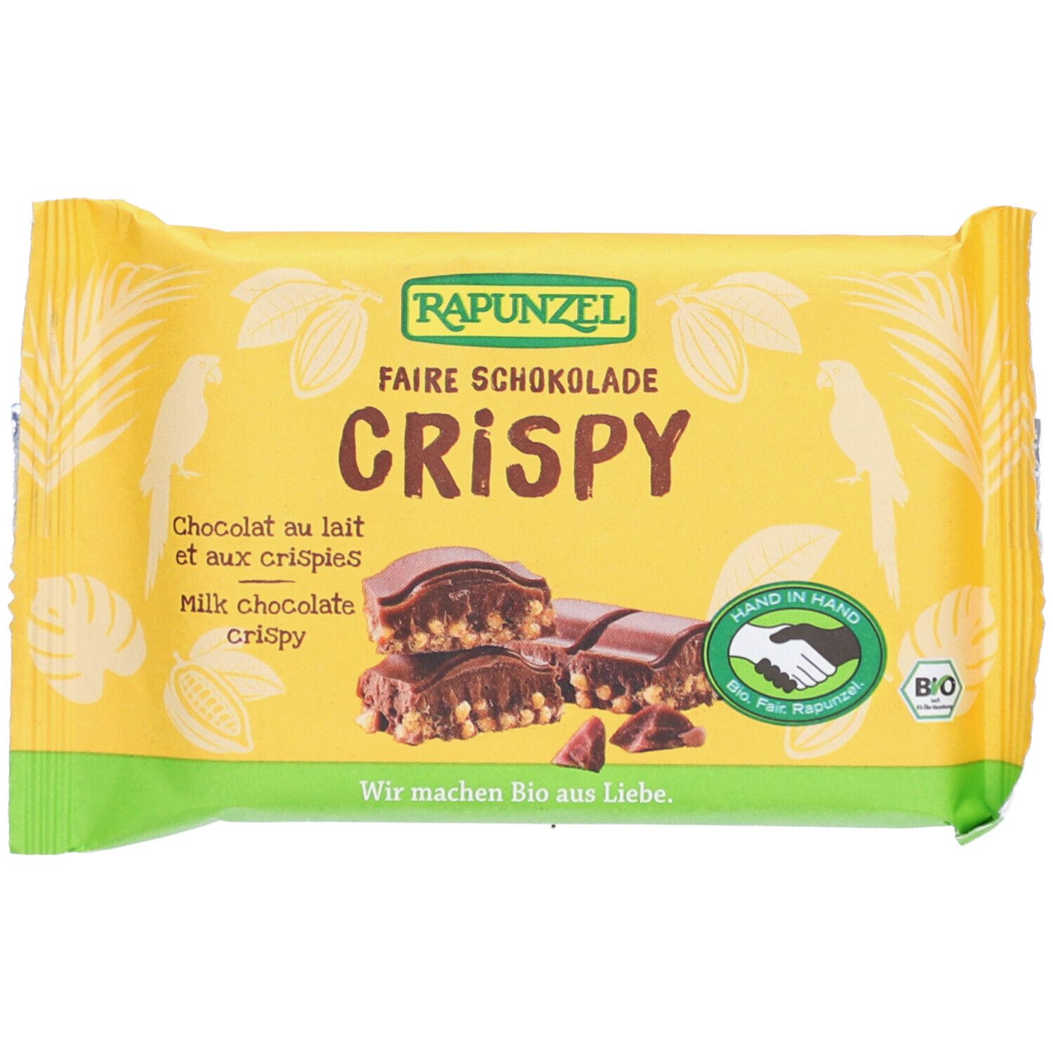 Emballage jaune "RAPUNZEL Faire Schokolade Crispy". Image du produit. Texte : "Crispy", "Chocolat au lait et aux crispies". Label bio.