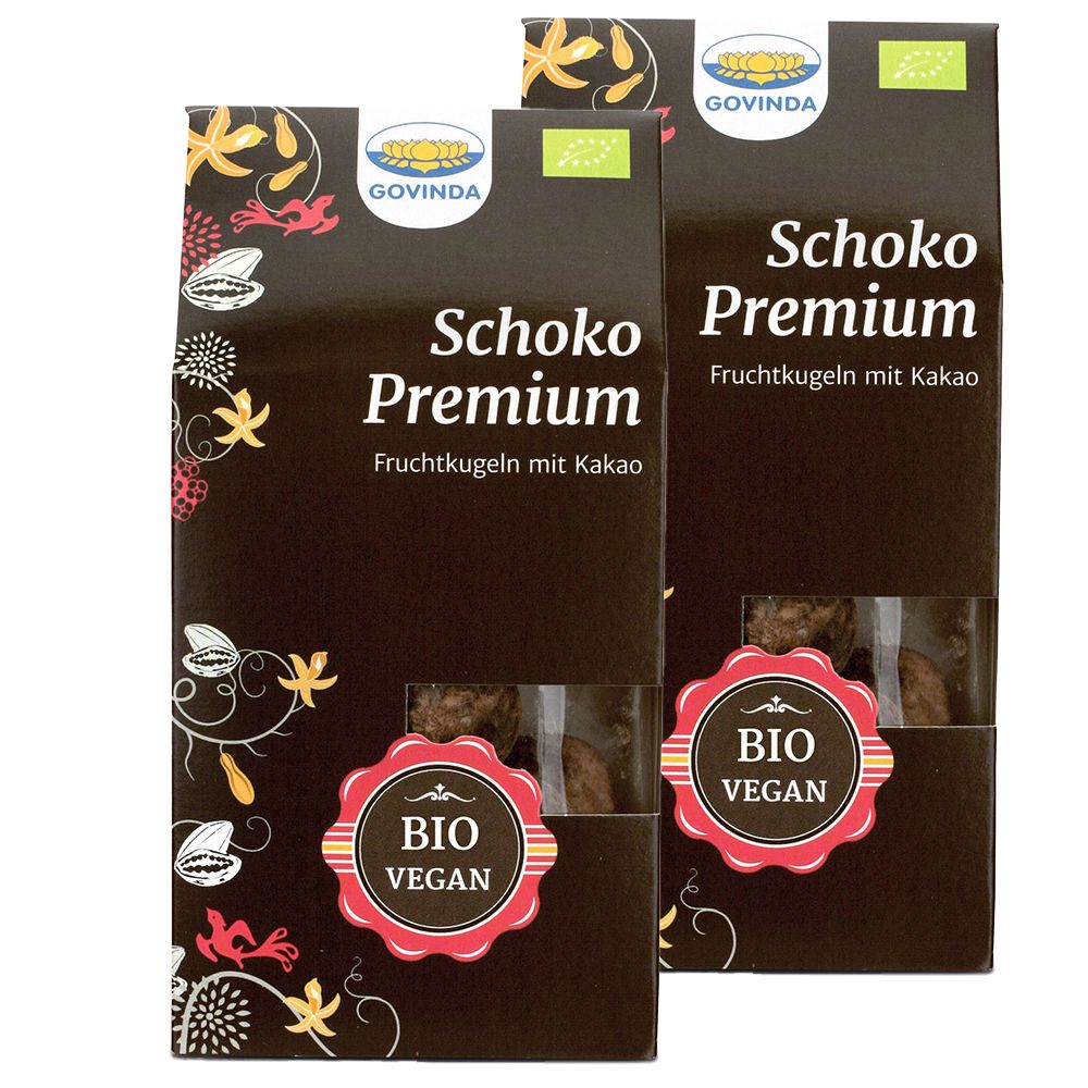 Deux boîtes de Schoko Premium Fruchtkugeln. Inscriptions : Govinda, Bio, Vegan. Fenêtres révèlent les boules.