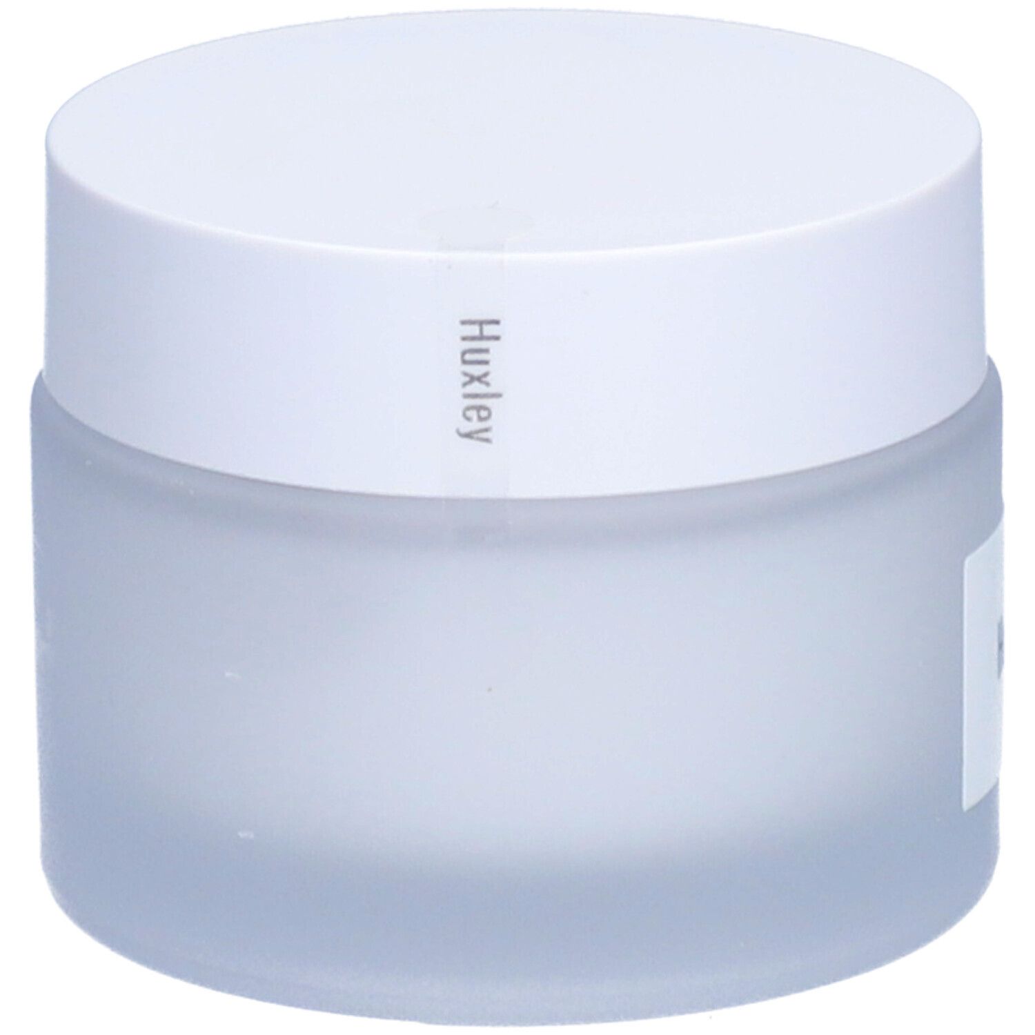 Pot de crème avec couvercle blanc. Huxley est écrit sur le couvercle. Le pot est laiteux.