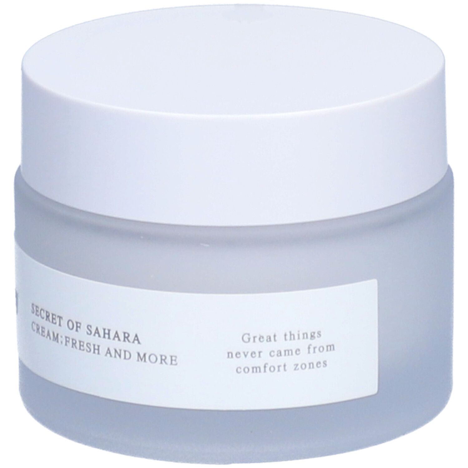 Pot de crème avec couvercle blanc. L'étiquette indique Secret of Sahara Cream Fresh And More. Citation.