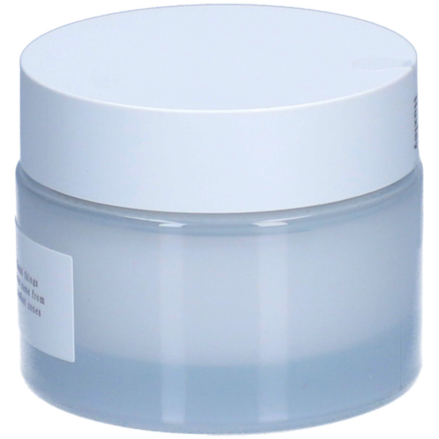 Pot de crème avec couvercle blanc. Étiquette avec texte.