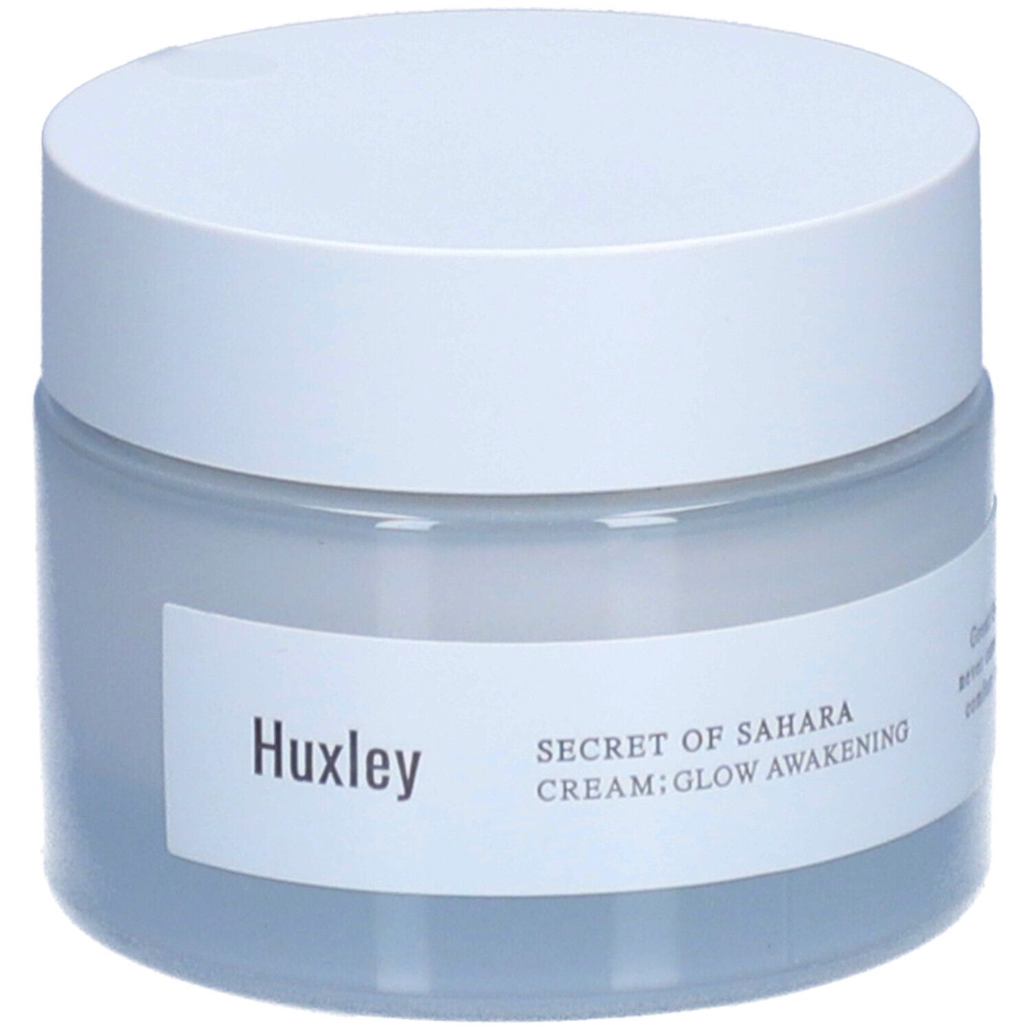 Pot de crème avec couvercle blanc. Étiquette "Huxley" et "SECRET OF SAHARA CREAM; GLOW AWAKENING".