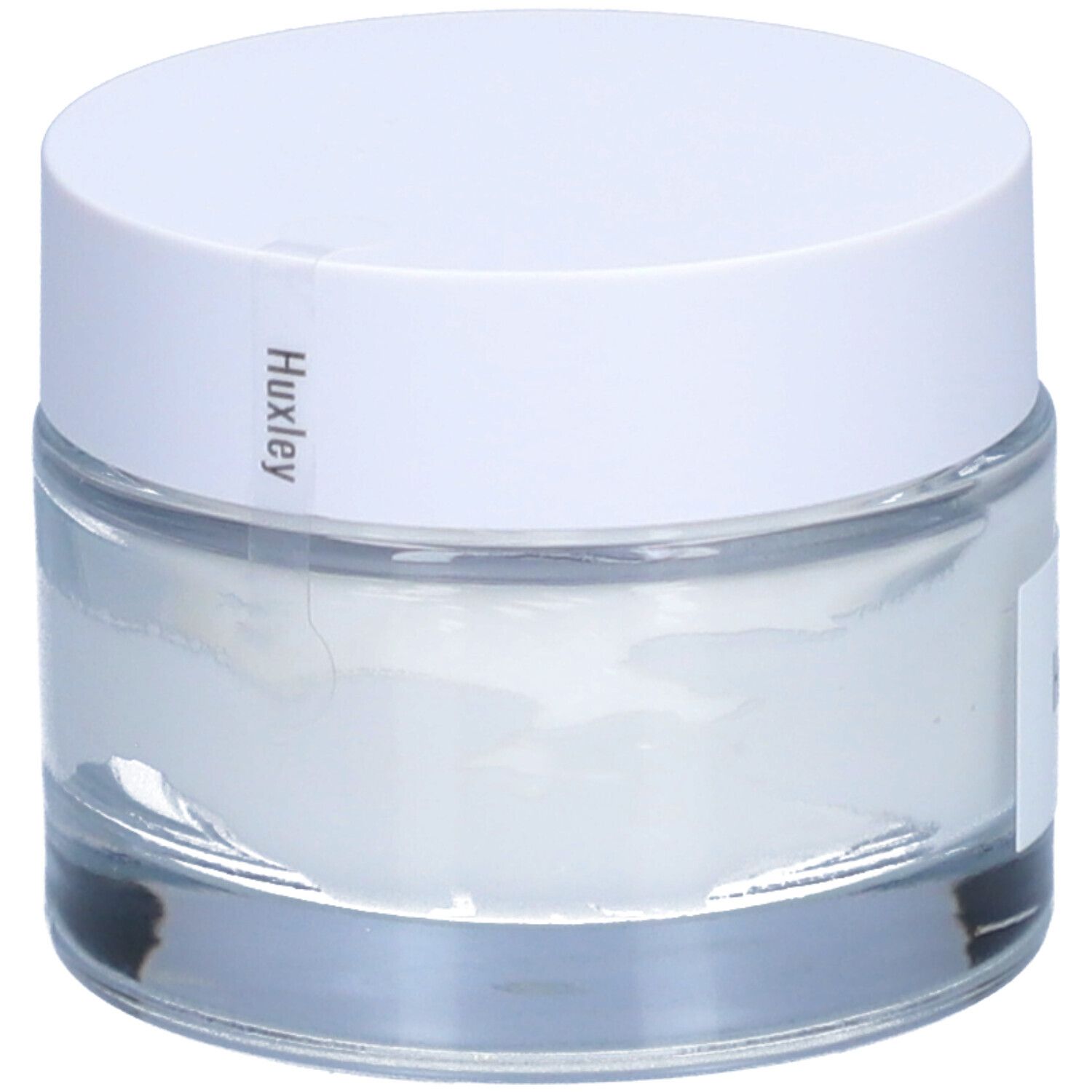 Pot de crème avec couvercle blanc. "Huxley" est écrit sur le couvercle.