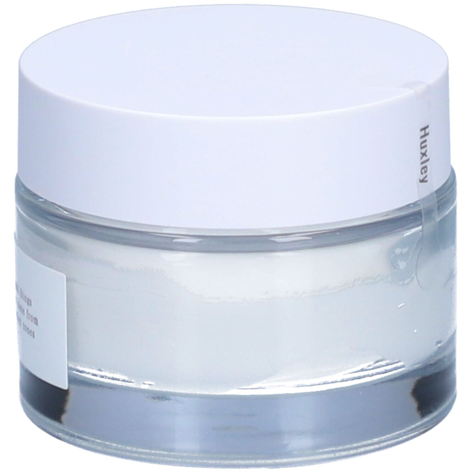 Pot de crème avec couvercle blanc. "Huxley" est écrit sur le couvercle.