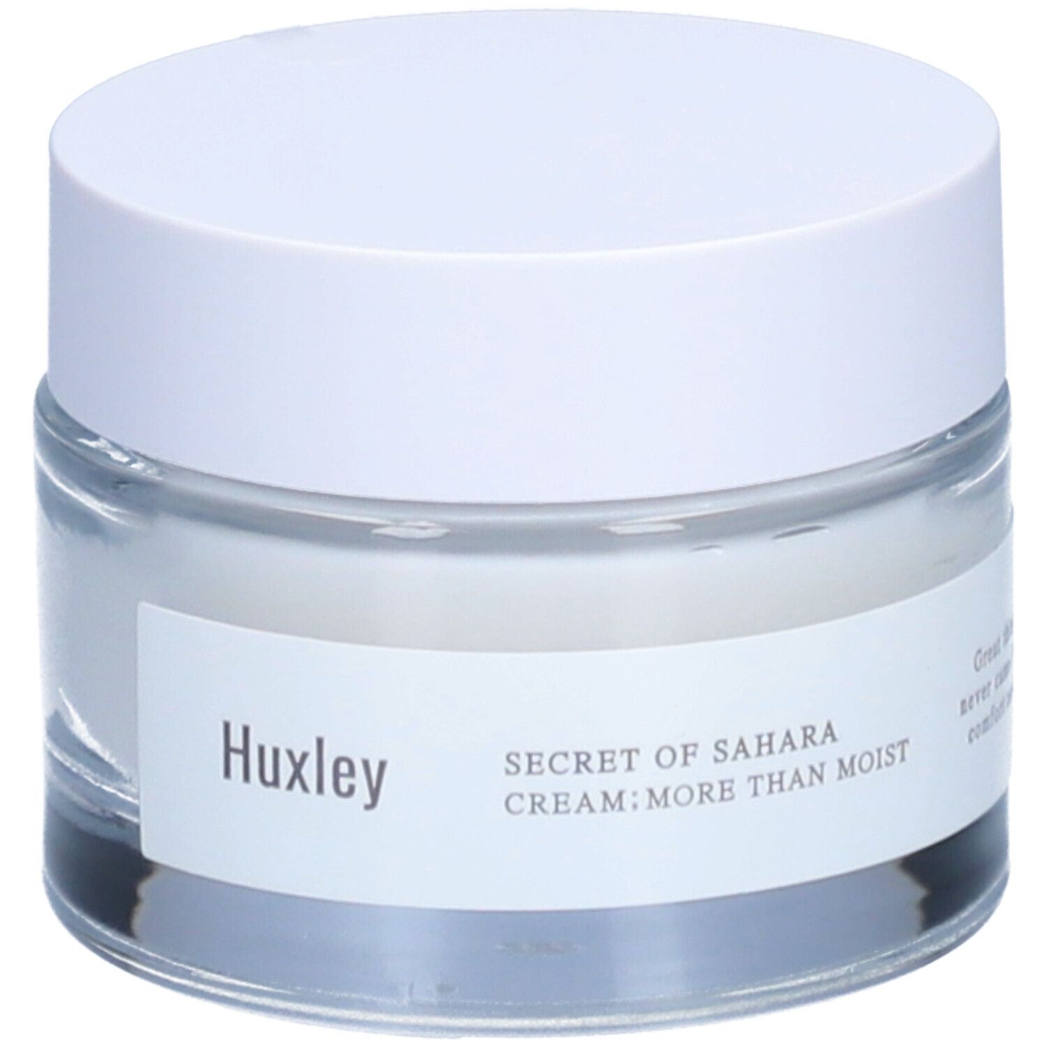 Pot de crème avec couvercle blanc. L'étiquette indique "Huxley" et "SECRET OF SAHARA CREAM; MORE THAN MOIST".