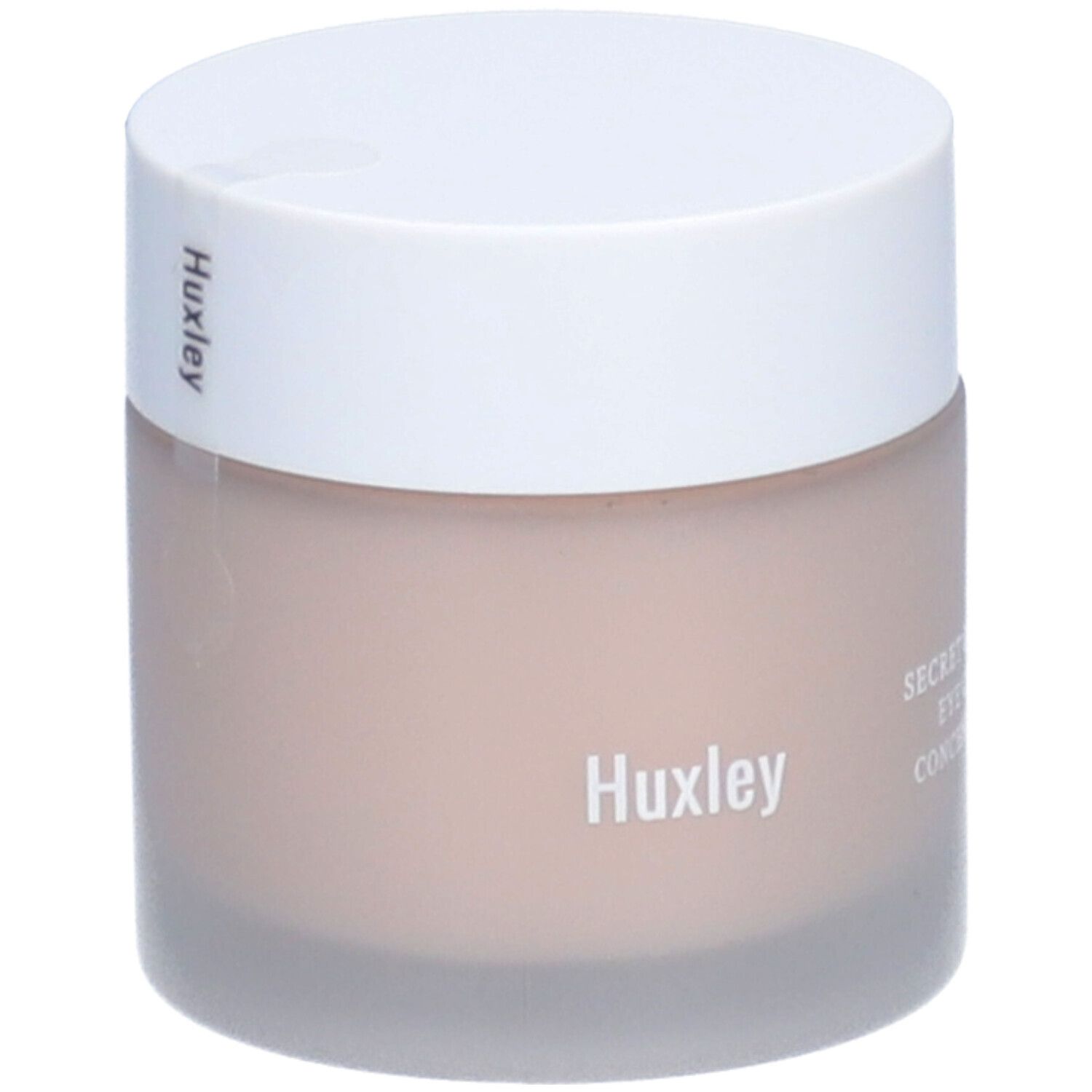 Pot avec couvercle blanc. Le pot porte les inscriptions "Huxley" et "SECRET OF SAHARA EYE CREAM: CONCENTRATE ON".