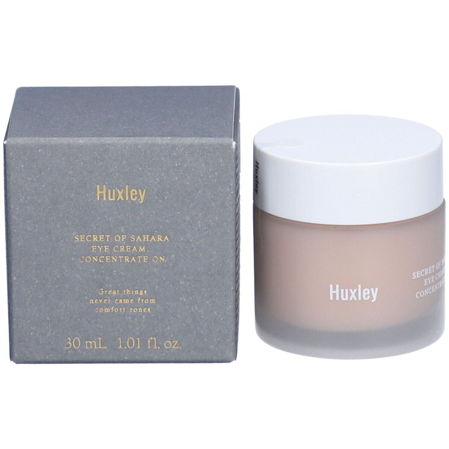 Pot avec couvercle blanc et boîte grise. Sur la boîte, on peut lire "Huxley" et "SECRET OF SAHARA EYE CREAM. CONCENTRATE ON".