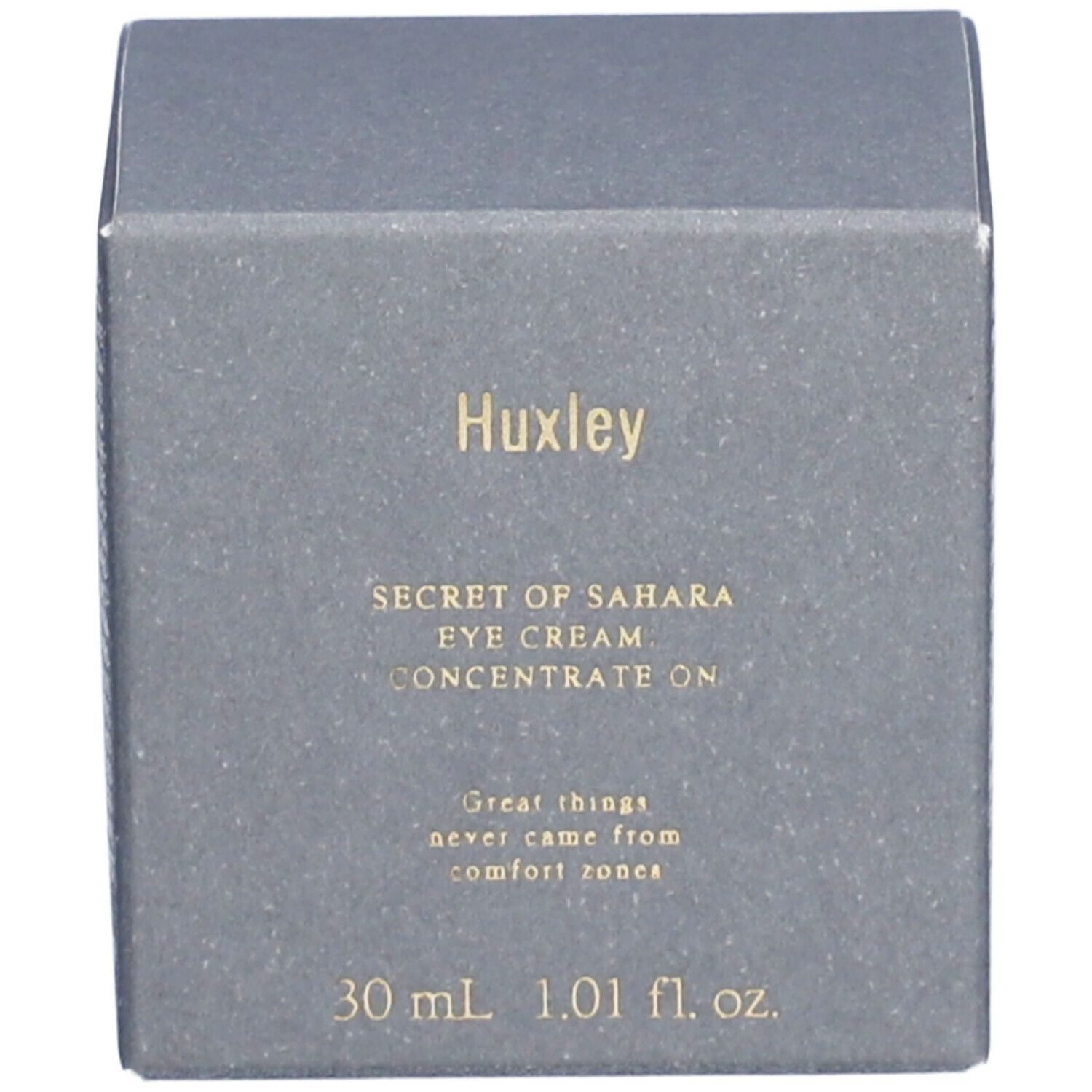 Boîte grise avec écriture dorée. Sur la boîte, on peut lire "Huxley" et "SECRET OF SAHARA EYE CREAM. CONCENTRATE ON".