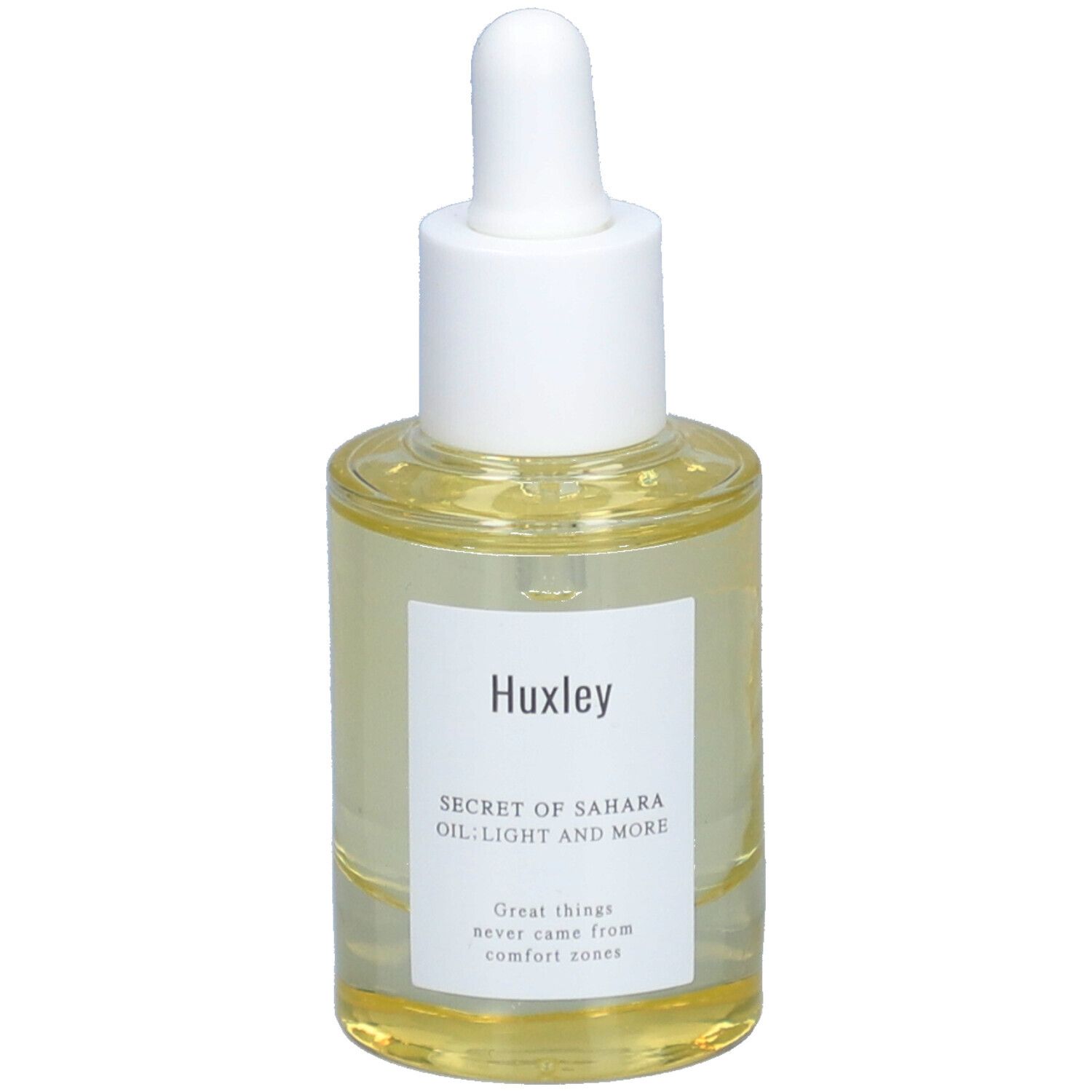 Huile claire dans un flacon en verre avec bouchon blanc et pipette. Étiquette avec nom du produit et slogan.