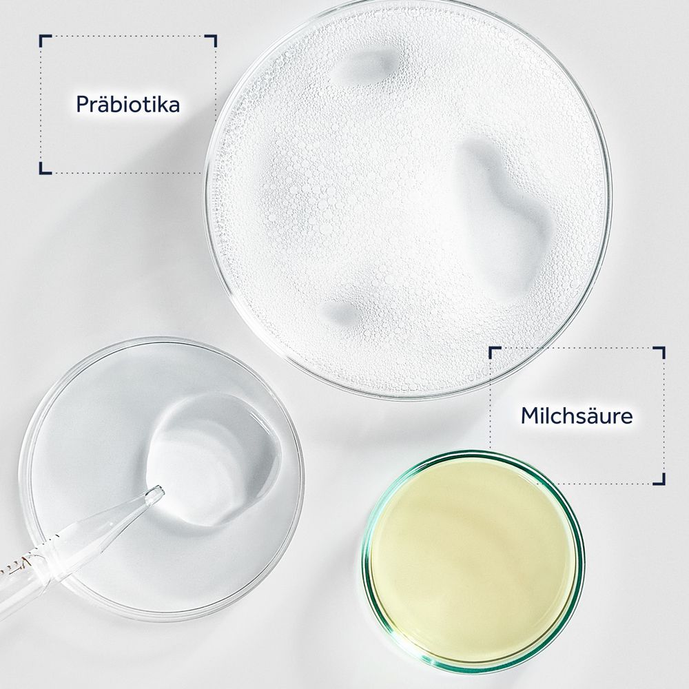 Boîtes de Pétri contenant des prébiotiques, de l'acide lactique et une huile jaune, probablement de l'huile d'amande douce.