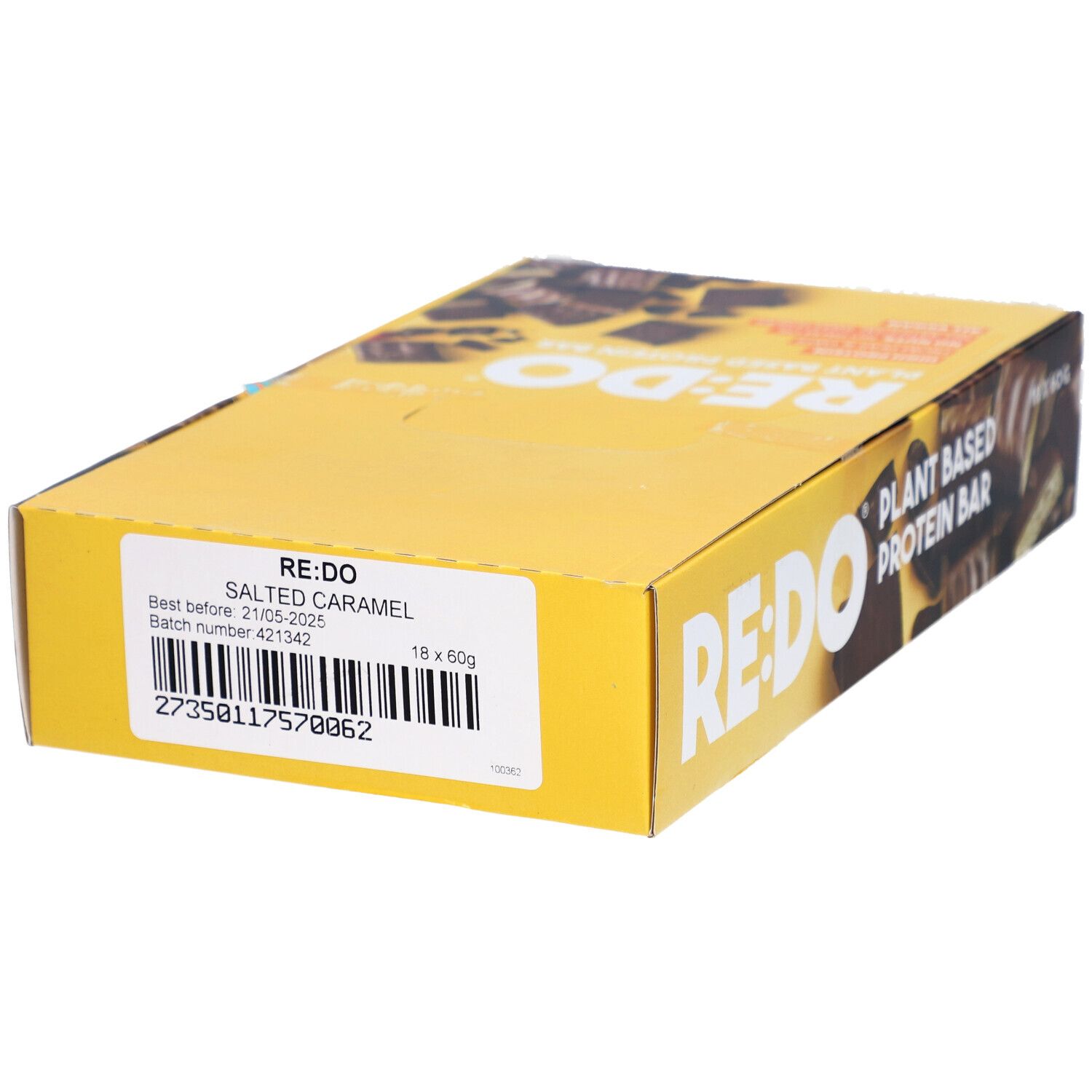 Boîte jaune avec logo RE:DO et texte. Autocollant avec inscription : Salted Caramel. Date limite et numéro de lot.