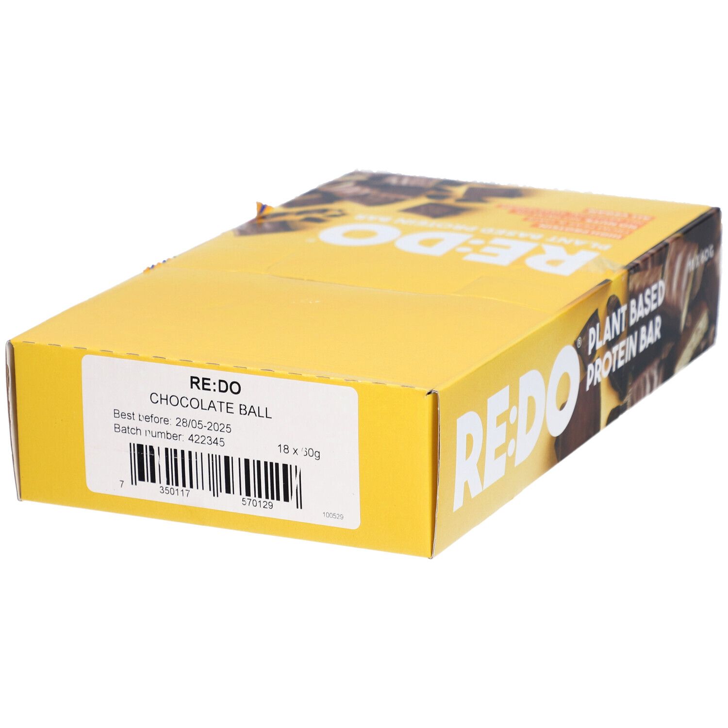 Boîte jaune avec logo RE:DO et texte. Inscription : Chocolate Ball. Contient numéro de lot et date de péremption.