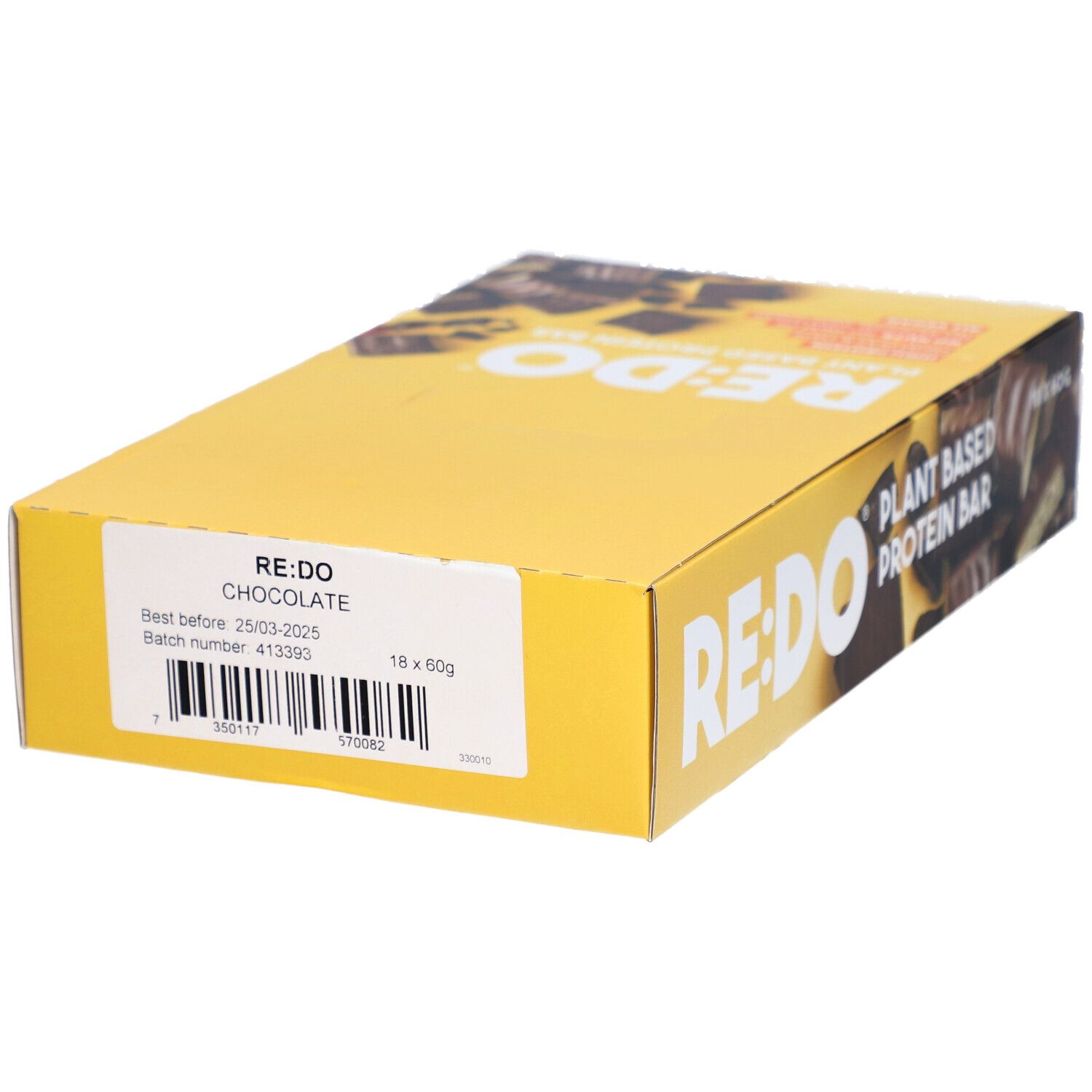 Boîte jaune de barres chocolatées RE:DO. Inscription : Plant Based Protein Bar. Autocollant : RE:DO Chocolate, à consommer de préférence avant le 25.03.2025, 18 x 60g.