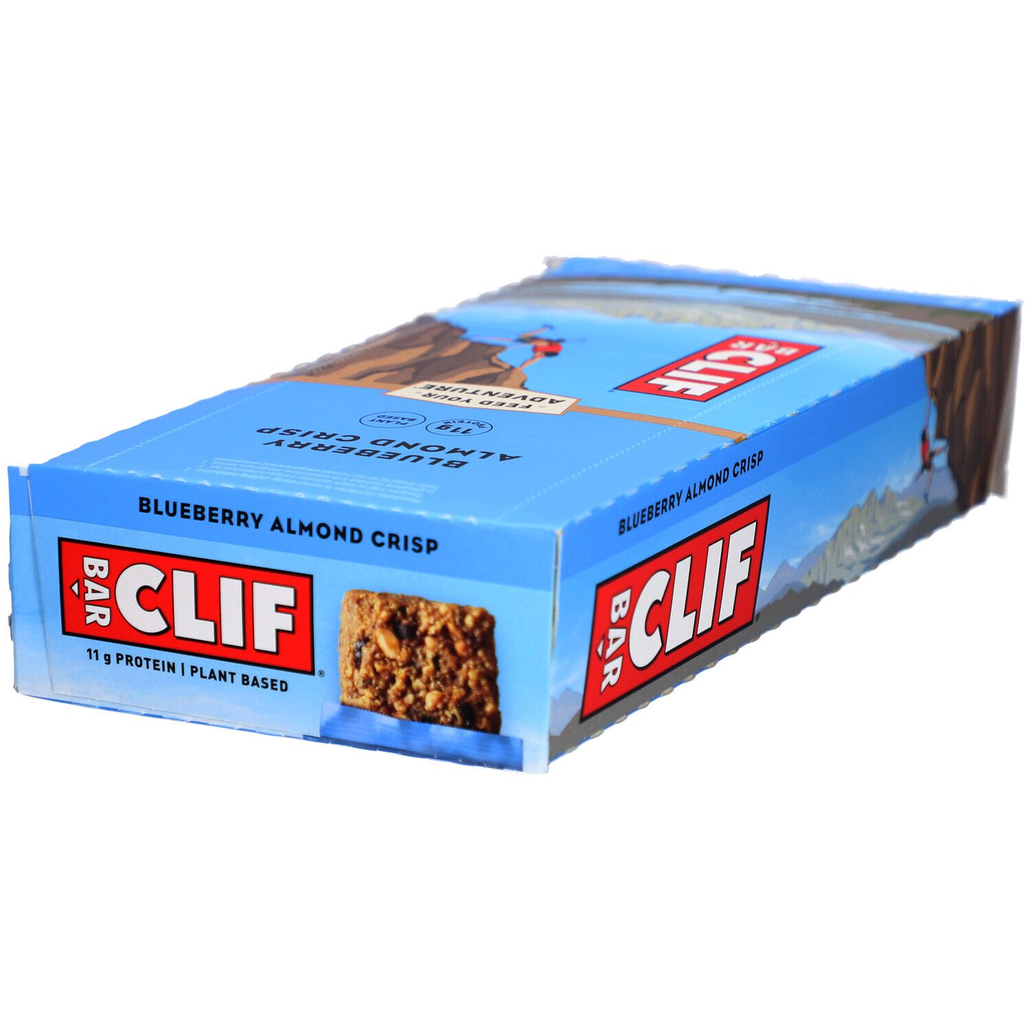 Emballage bleu et blanc CLIF Bar. Inscription Blueberry Almond Crisp. Barre énergétique visible.