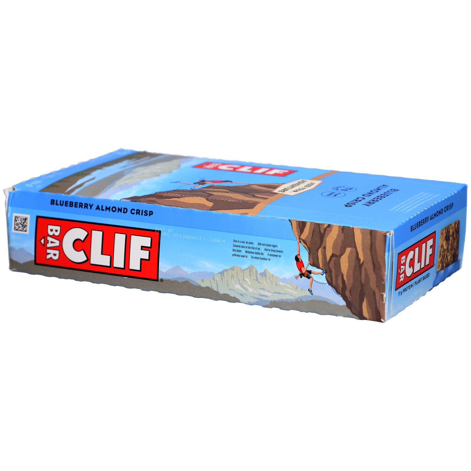 Emballage bleu et blanc CLIF Bar. Inscription Blueberry Almond Crisp. Barre énergétique visible.