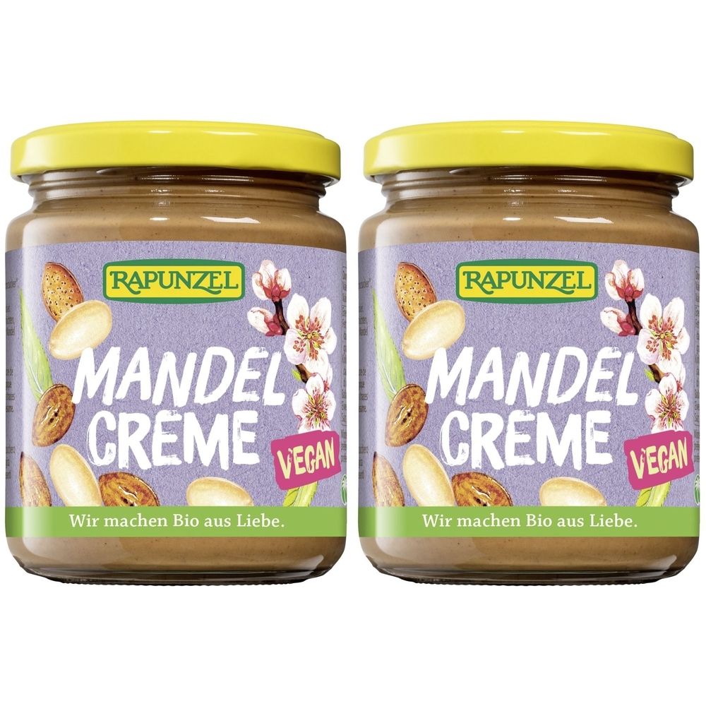 Deux pots de crème d'amandes avec des couvercles jaunes. Les étiquettes indiquent "RAPUNZEL MANDEL CREME VEGAN".