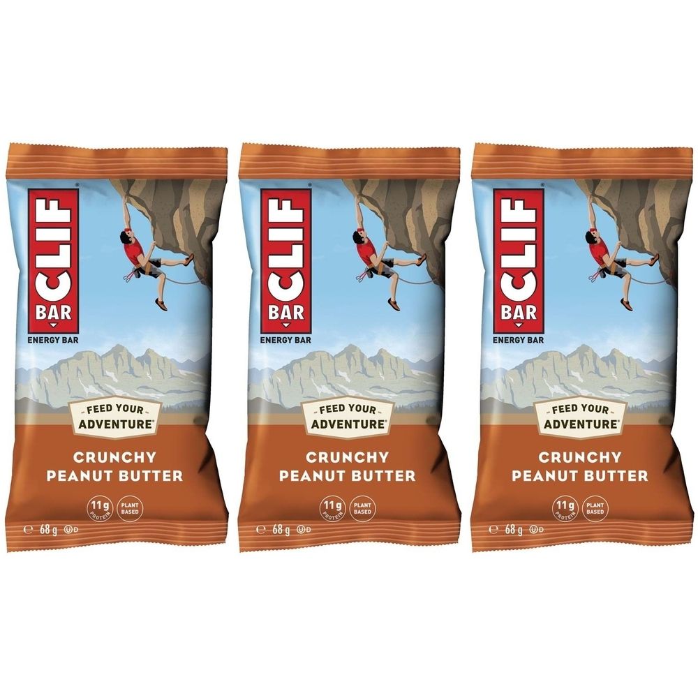 Trois barres énergétiques CLIF BAR. Inscription : Crunchy Peanut Butter, 11g protéines. Image d'un grimpeur.