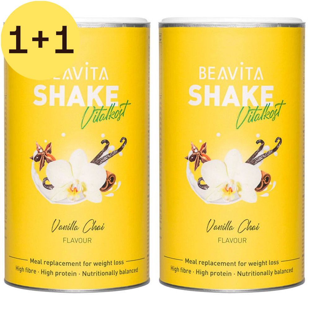 Deux boîtes jaunes avec impression du produit. Inscription: BEAVITA SHAKE Vitalkost, Vanilla Chai. Avec autocollant 1+1.
