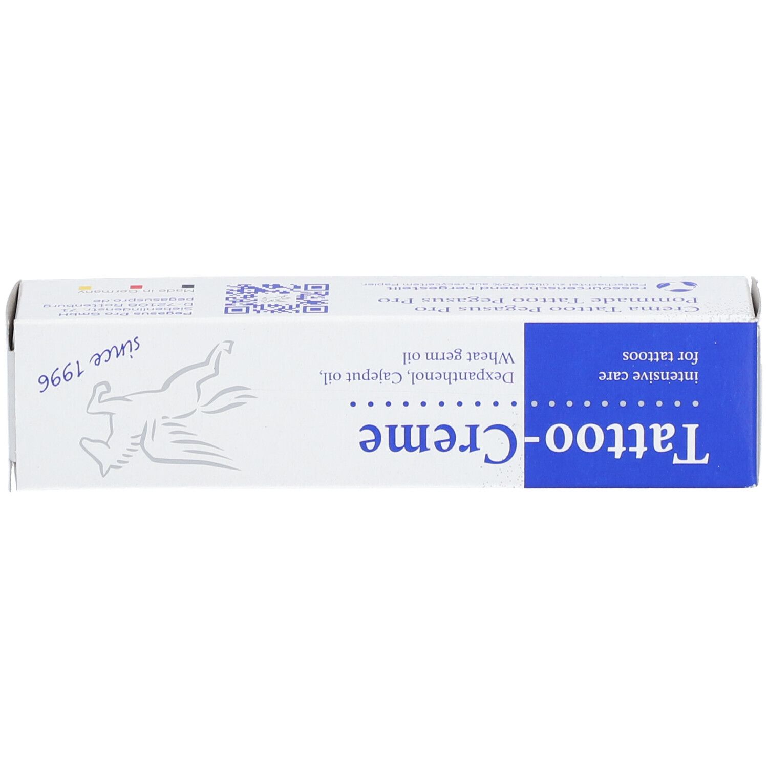 Boîte Tattoo-Creme avec zone bleue et logo. Contient dexpanthénol, huile de cajeput et huile de germe de blé. Depuis 1996. Soin intensif.