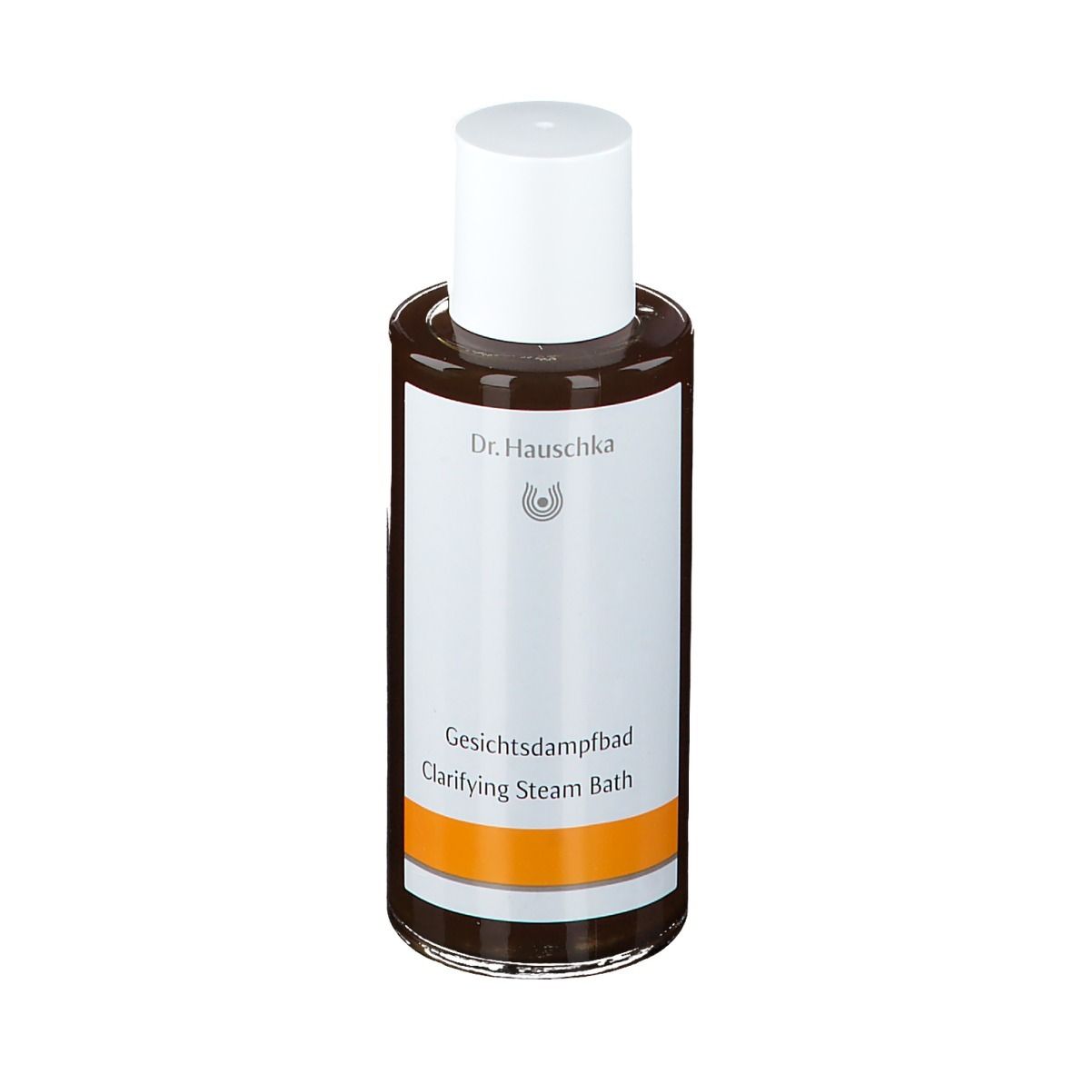 Flacon en verre brun avec bouchon blanc. Étiquette avec nom du produit et marque Dr. Hauschka. Bande orange.