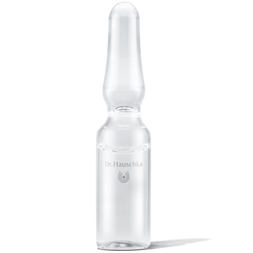 Ampoule en verre transparent avec liquide. Logo et texte Dr. Hauschka.
