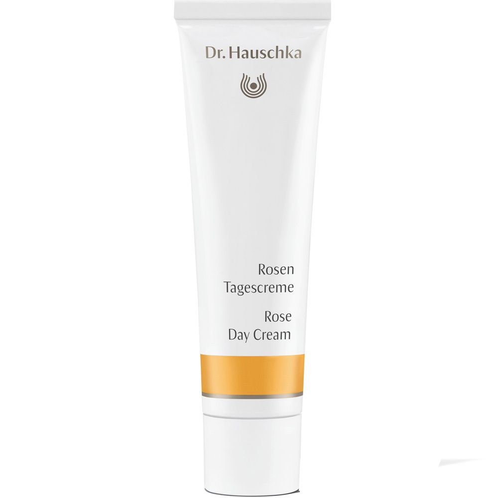 Tube blanc avec logo Dr. Hauschka, inscription Rosen Tagescreme et bande orange.