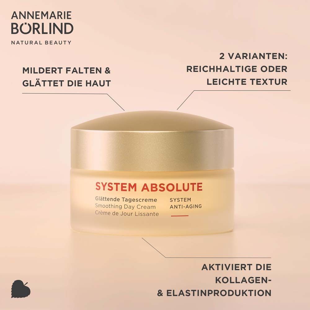 Pot de crème avec couvercle doré. Inscription : SYSTEM ABSOLUTE, Glättende Tagescreme. Texte : Atténue les rides et lisse la peau.