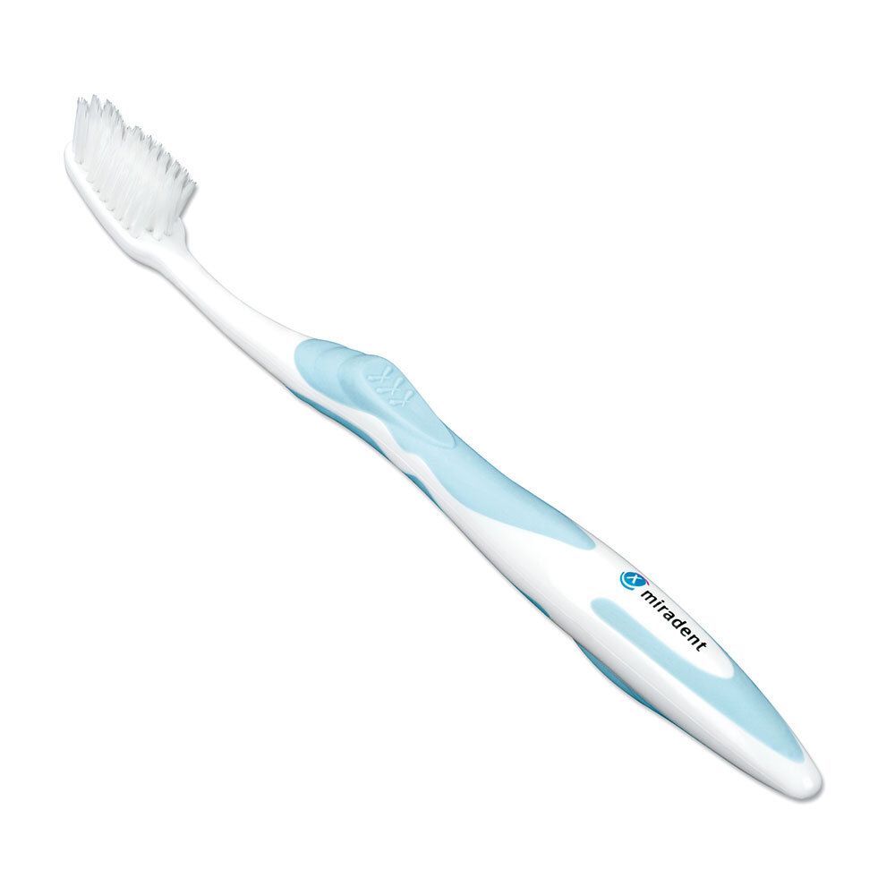 Brosse à dents blanche avec manche bleu et inscription 'miradent'.