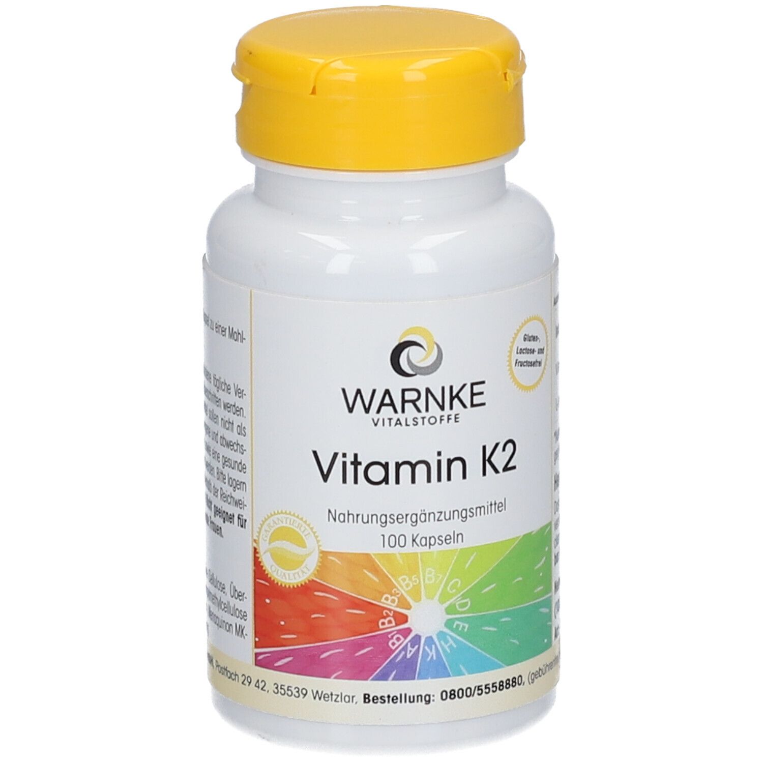 Flacon blanc à bouchon jaune. Inscription: WARNKE, Vitamine K2, complément alimentaire, 100 gélules. Logo et cercle coloré.