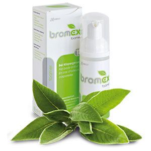 Flacon et emballage blancs avec logo vert 'bromex foamer'. Plante verte au premier plan.