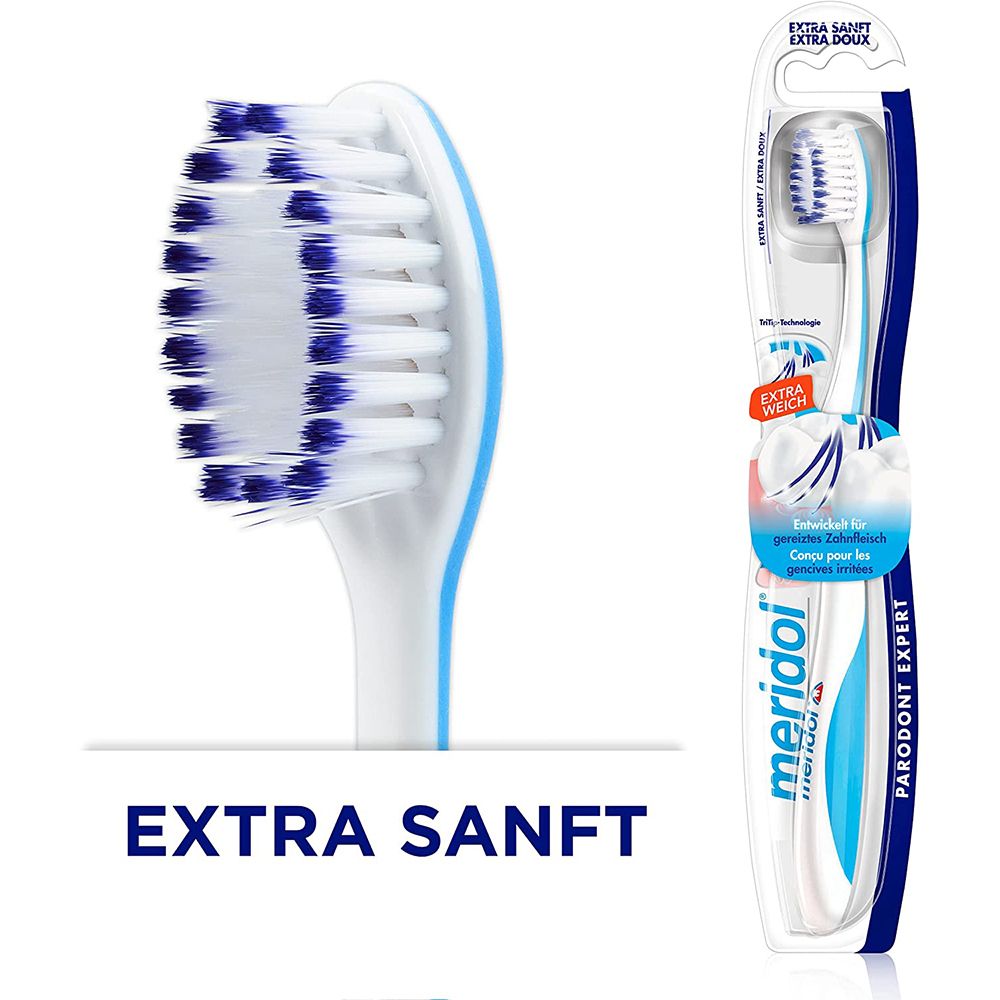 Brosse à dents avec poils bleus et blancs. Emballage avec nom du produit et mention 'Extra doux'.