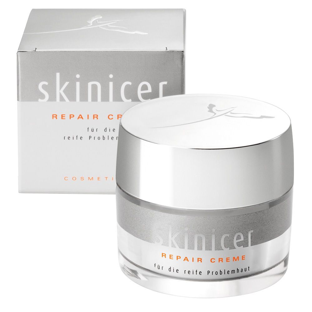 Pot de crème et boîte. Inscription : skinicer Repair Creme. Emballage gris et blanc.