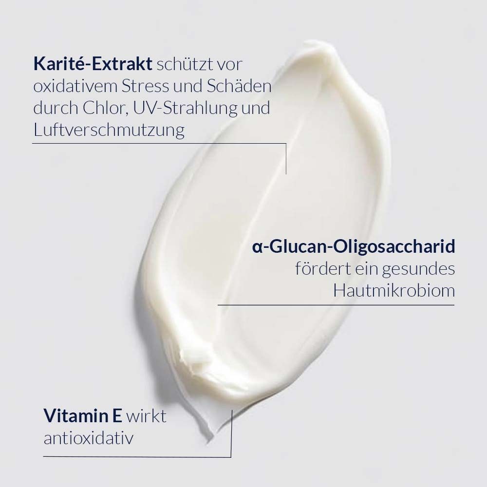 Tache de crème avec texte: Extrait de karité, Vitamine E, α-Glucan-Oligosaccharide. Crème blanche.