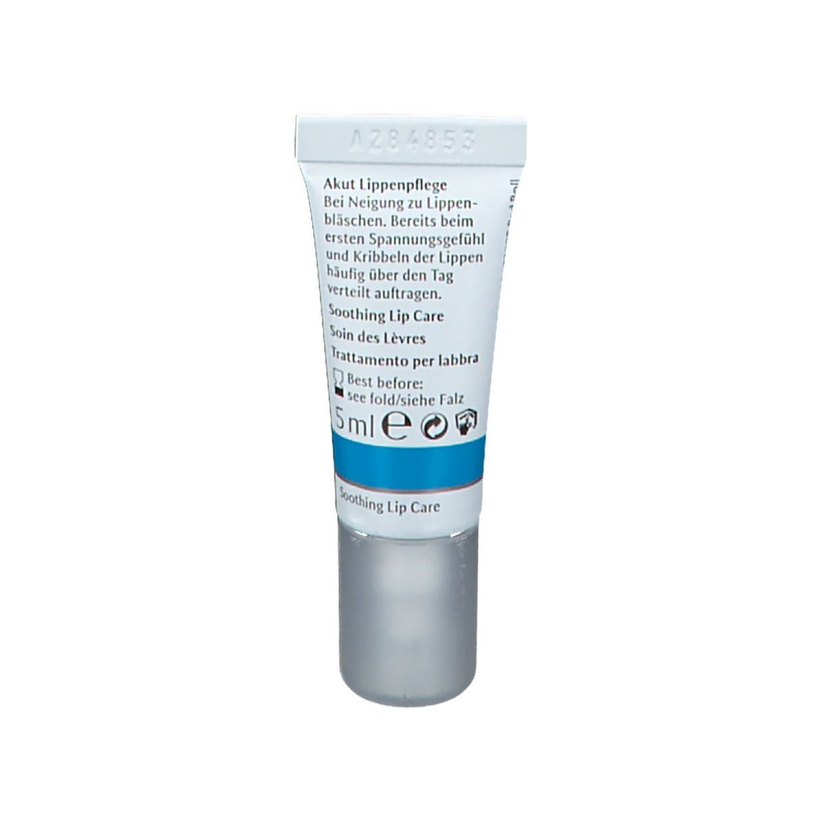 Dos du tube. Texte multilingue. Inscriptions: Akut Lippenpflege, Soothing Lip Care, 5ml. Bouchon gris.