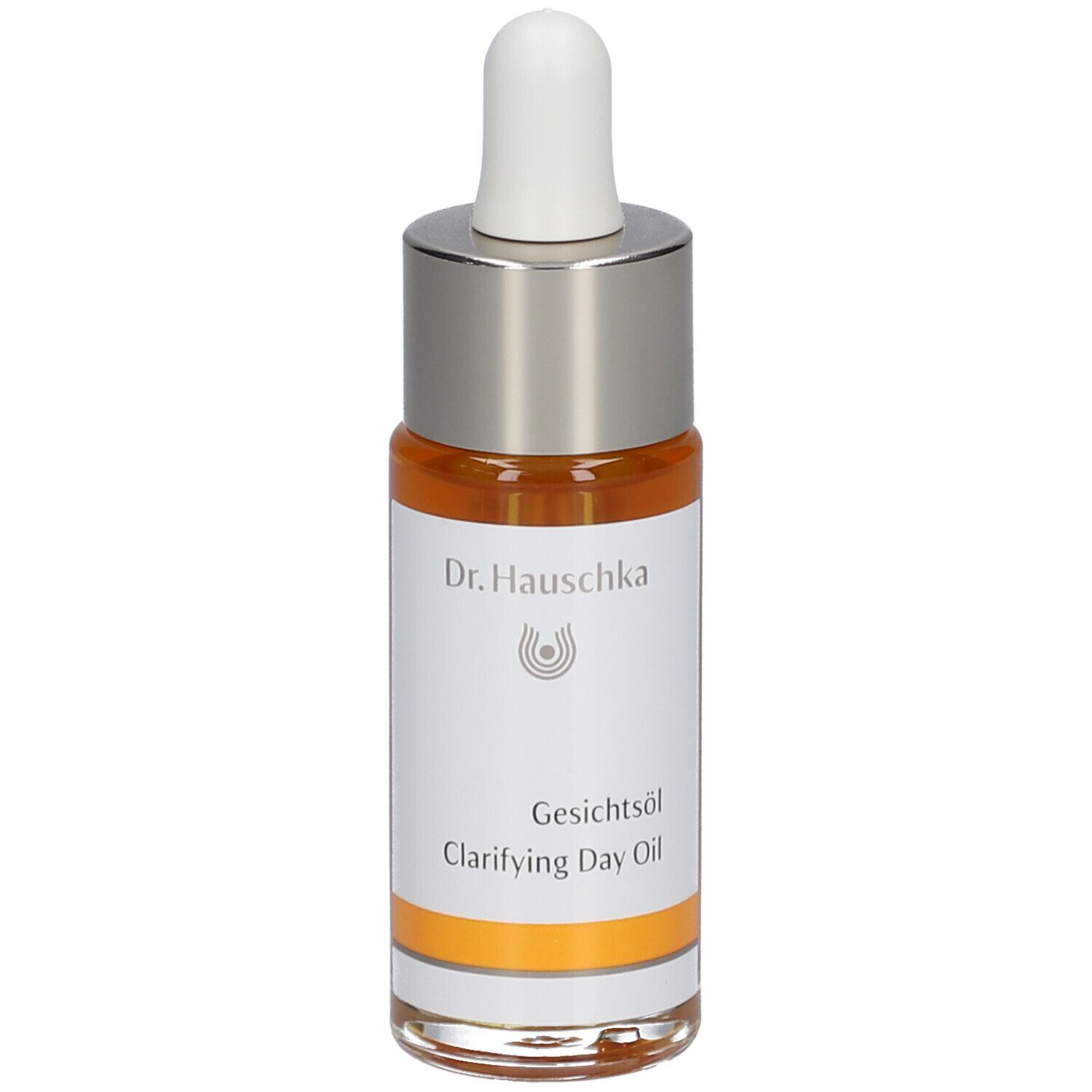 Flacon d'huile pour le visage avec pipette. Huile claire, orangée. Inscription : Dr. Hauschka, Gesichtsöl, Clarifying Day Oil.