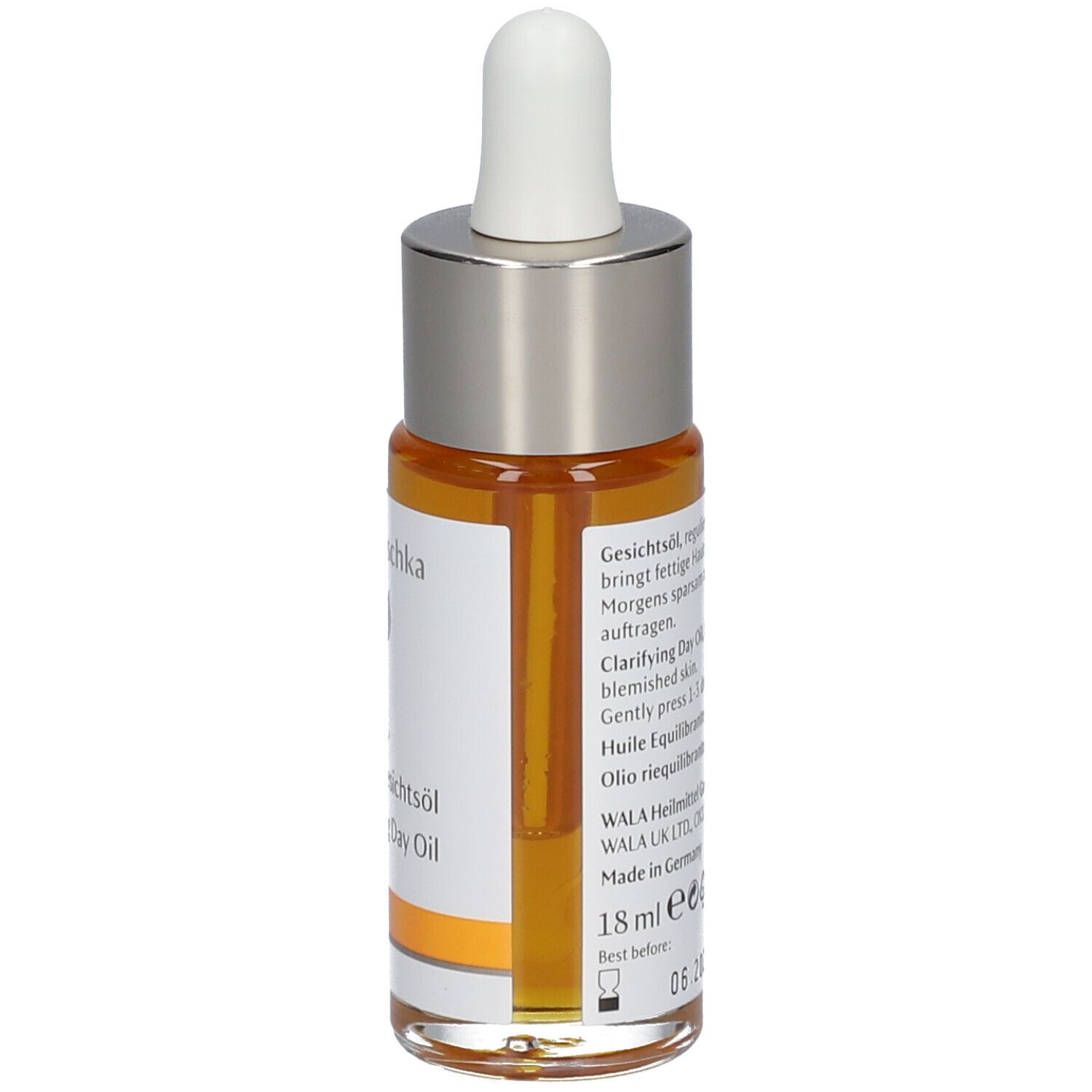 Flacon d'huile pour le visage avec pipette. Huile claire, orangée. Inscription : Dr. Hauschka, Gesichtsöl, Clarifying Day Oil.