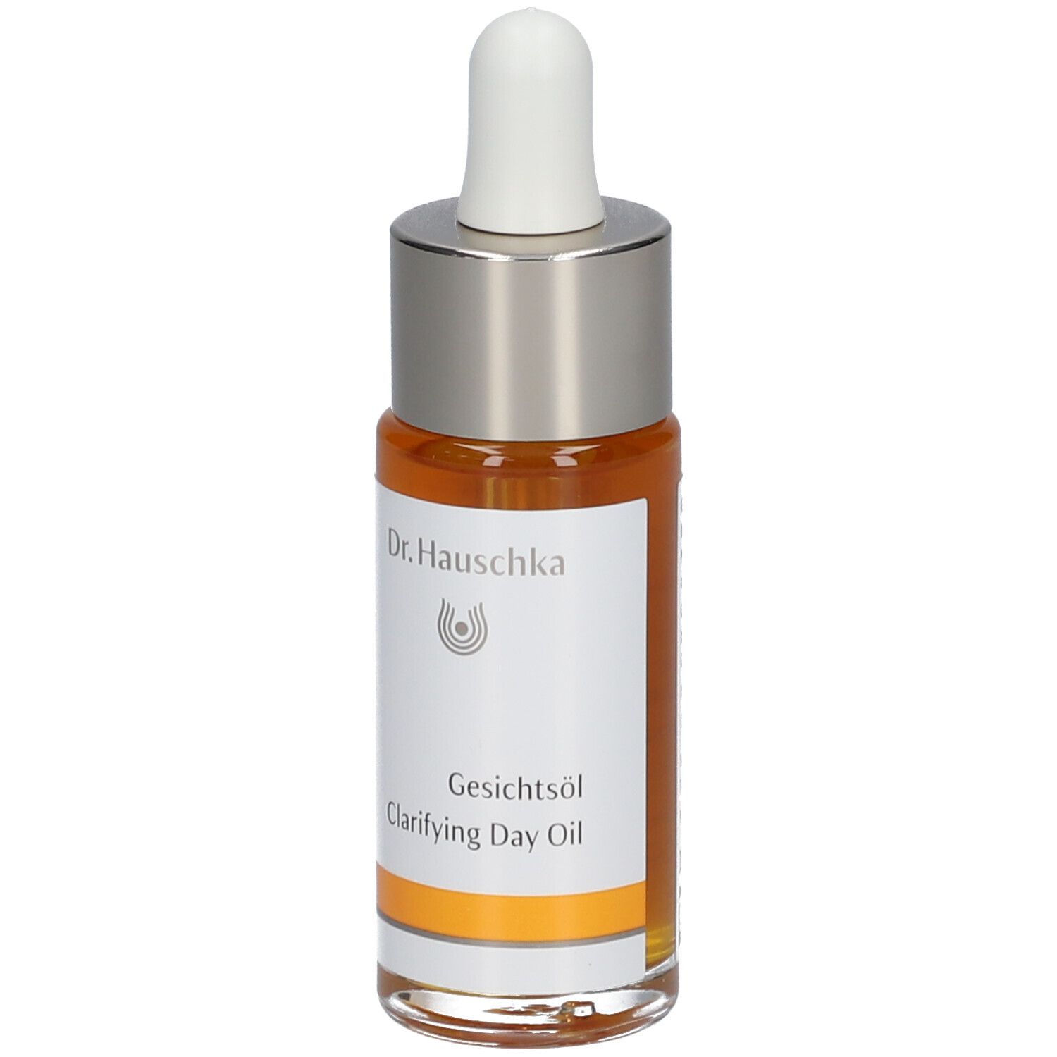 Flacon d'huile pour le visage avec pipette. Huile claire, orangée. Inscription : Dr. Hauschka, Gesichtsöl, Clarifying Day Oil.