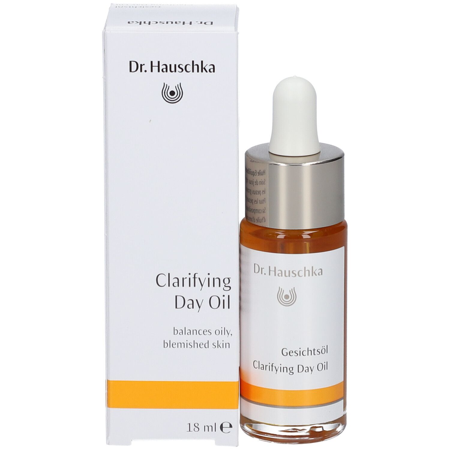 Flacon d'huile pour le visage avec pipette et emballage en carton. Inscription : Dr. Hauschka, Clarifying Day Oil, 18 ml.
