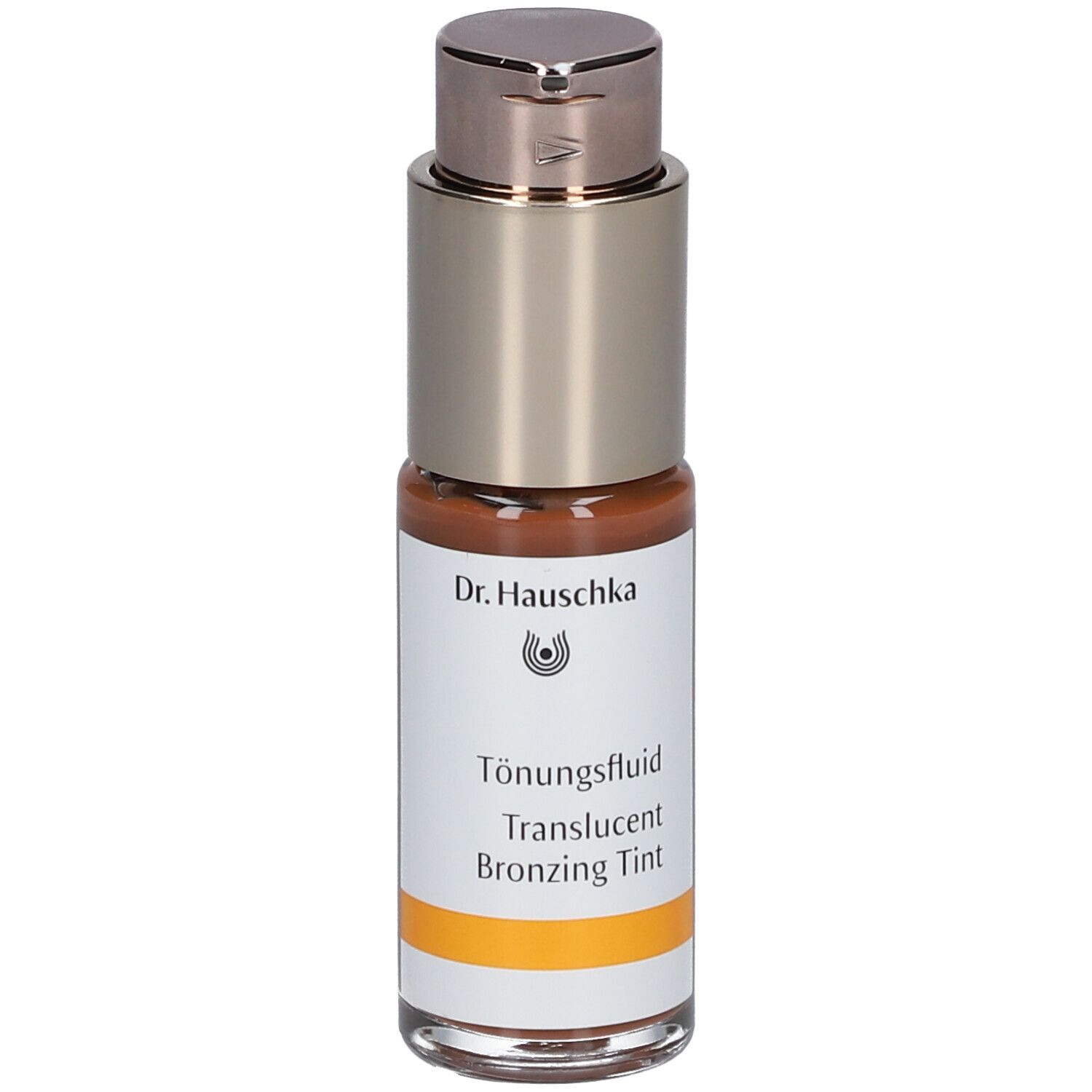 Fluide teinté brun dans un flacon avec pompe argentée. Inscription : Dr. Hauschka, Tönungsfluid, Translucent Bronzing Tint.