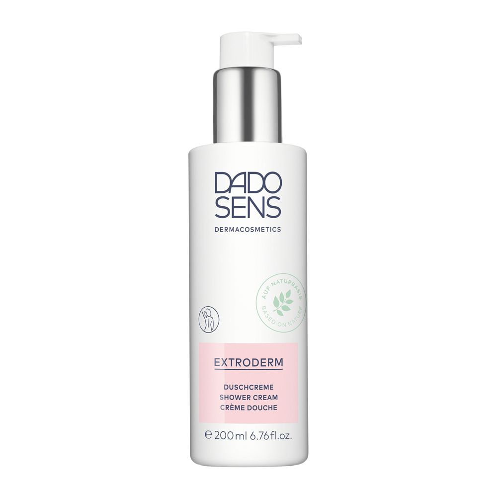 Flacon blanc avec pompe. Inscription DADO SENS, EXTRODERM Crème de douche. Logo feuilles vertes.