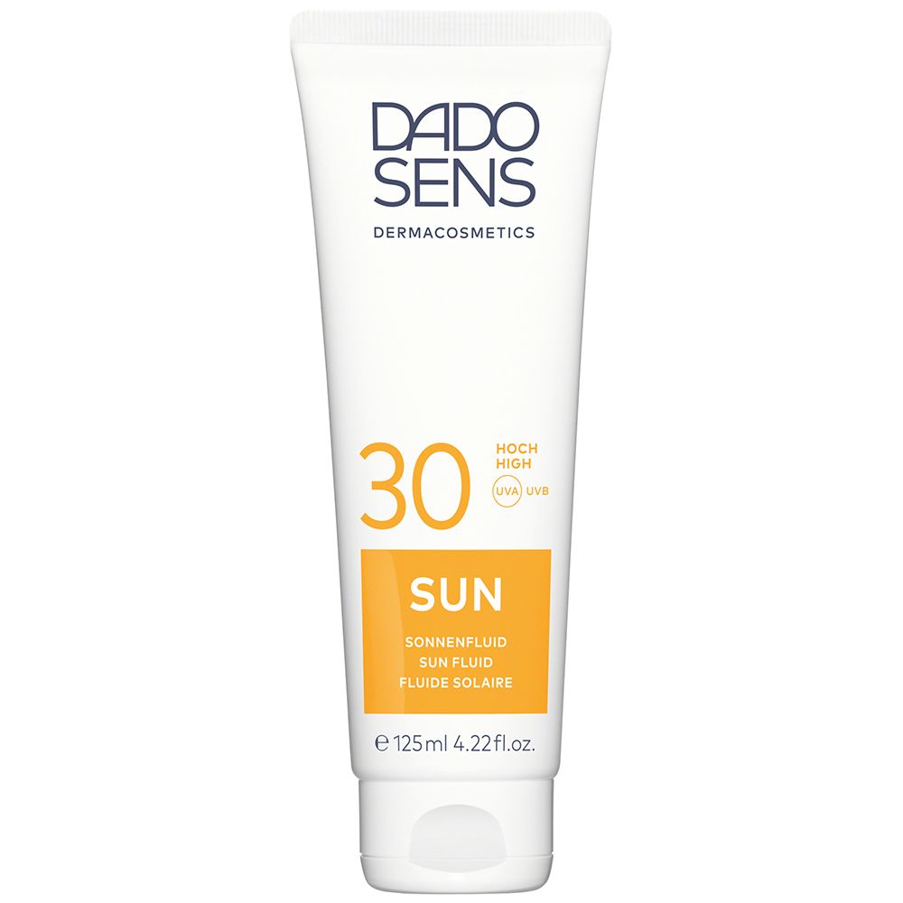 Tube blanc avec étiquette jaune. Inscription: DADO SENS, 30, SUN, Fluide solaire. Avec protection UV.