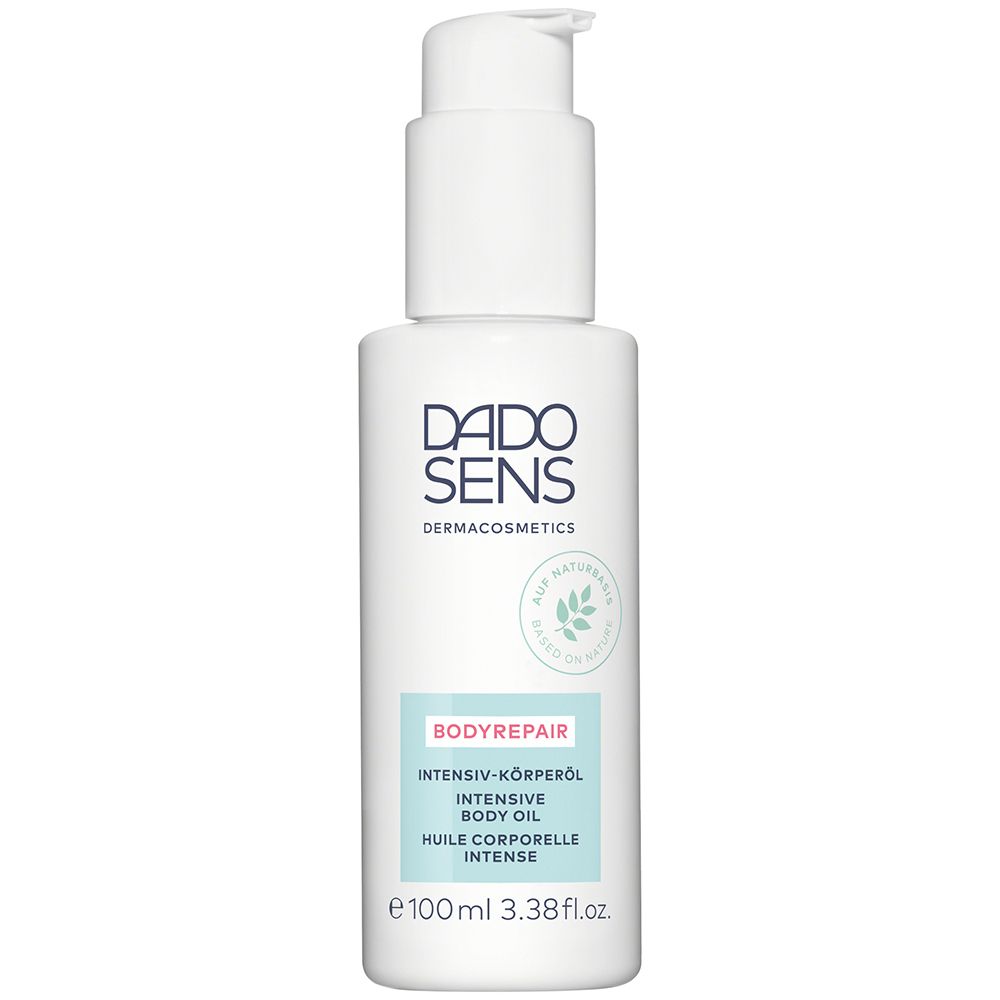 Flacon blanc avec pompe. DADO SENS BODYREPAIR Huile Corps Intense. Inscription: BODYREPAIR, Huile corporelle intense.