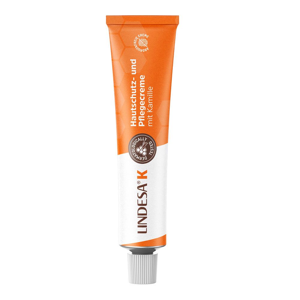 Tube orange avec bouchon blanc. Inscription: Crème protectrice et soin à la camomille. Marque: LINDESA K.