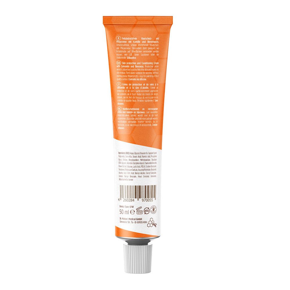 Dos d'un tube orange. Texte en plusieurs langues. Code-barres et informations de fabrication.